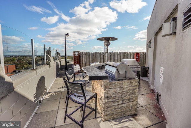 view of patio featuring an outdoor kitchen, an outdoor bar, and grilling area