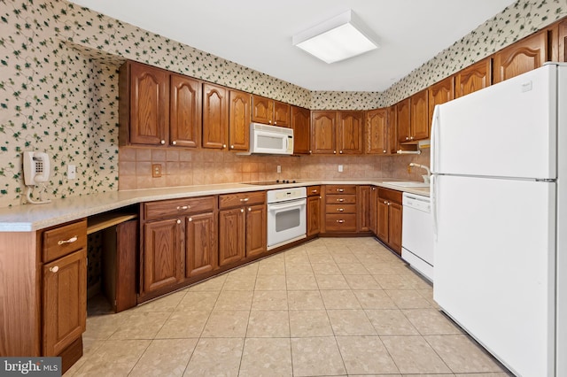 kitchen with tasteful backsplash, white appliances, sink, and light tile patterned floors