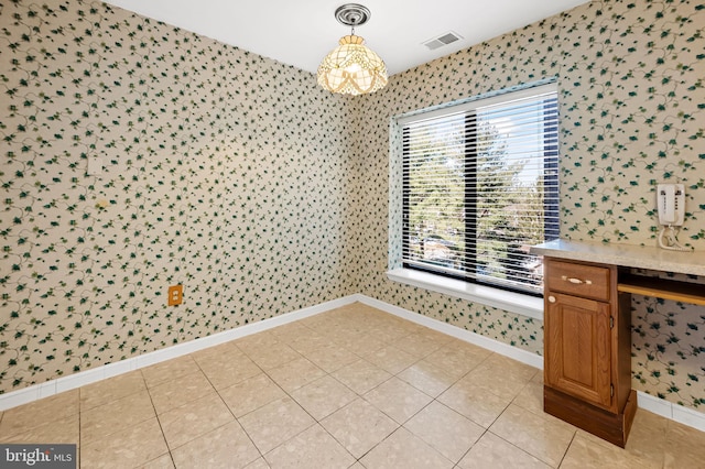 unfurnished dining area with light tile patterned floors