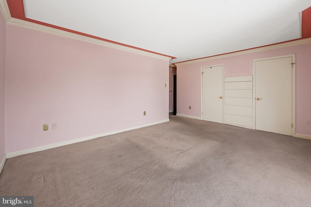 interior space with ornamental molding and carpet flooring