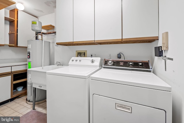 laundry area featuring cabinets, sink, washer and dryer, and light tile patterned floors