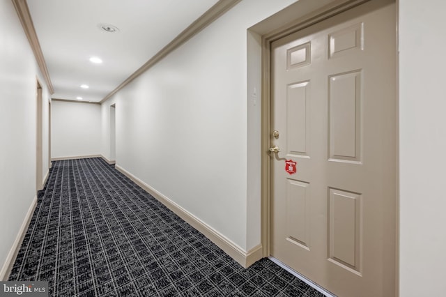 hall with crown molding and carpet flooring