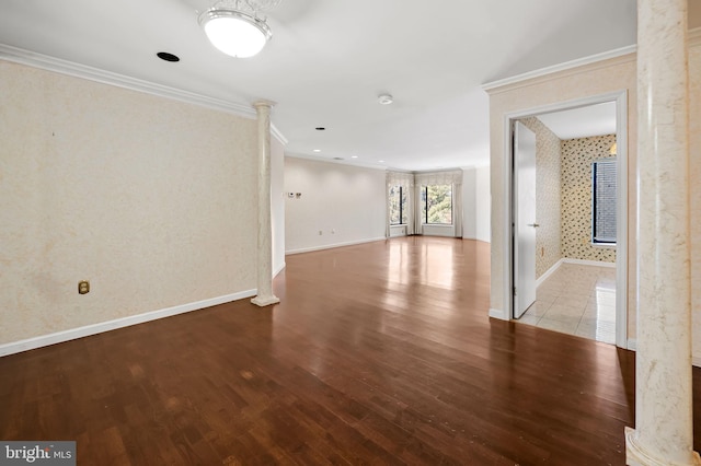 spare room with light hardwood / wood-style flooring, ornamental molding, and decorative columns