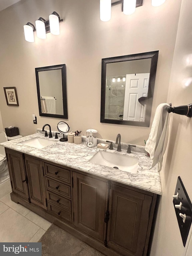 bathroom with vanity, tile patterned floors, and toilet