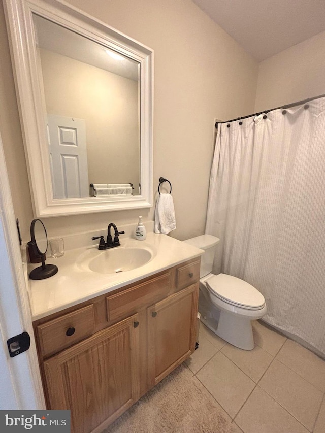 bathroom with tile patterned floors, toilet, and vanity