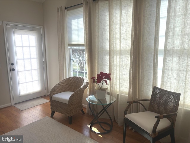 sitting room with hardwood / wood-style flooring