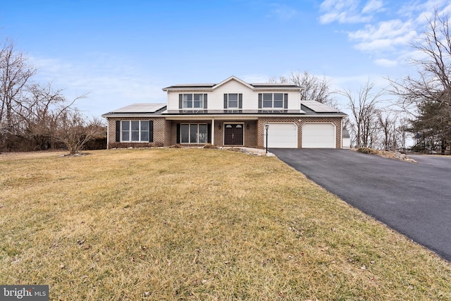 view of property featuring a front lawn and solar panels