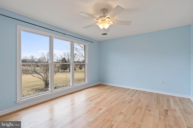 empty room featuring ceiling fan and light hardwood / wood-style floors