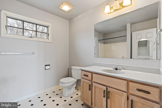 bathroom with vanity, toilet, and a shower