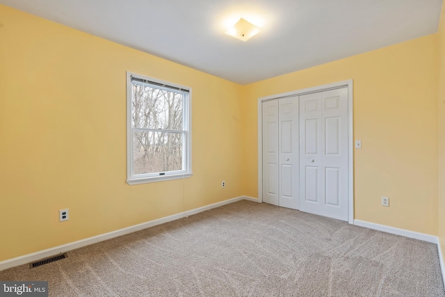 unfurnished bedroom featuring a closet and carpet