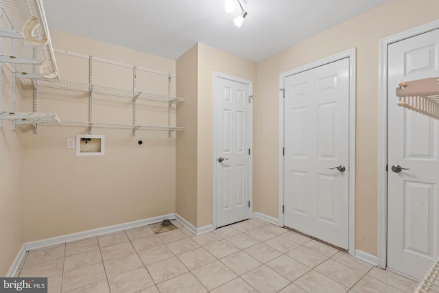 laundry area featuring hookup for a washing machine, electric dryer hookup, and light tile patterned floors