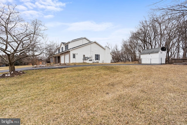 view of yard with a storage shed and a garage