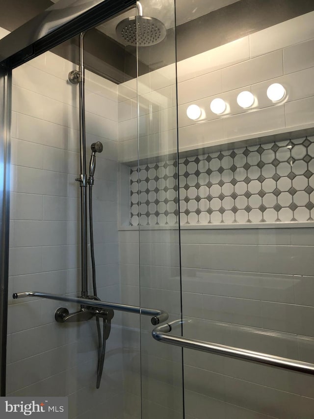 bathroom featuring a shower with shower door