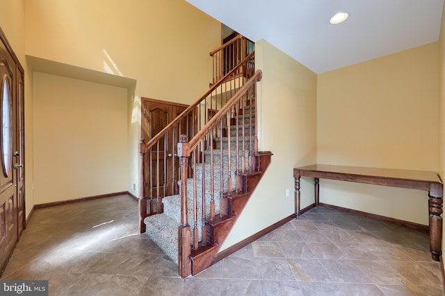 staircase featuring baseboards