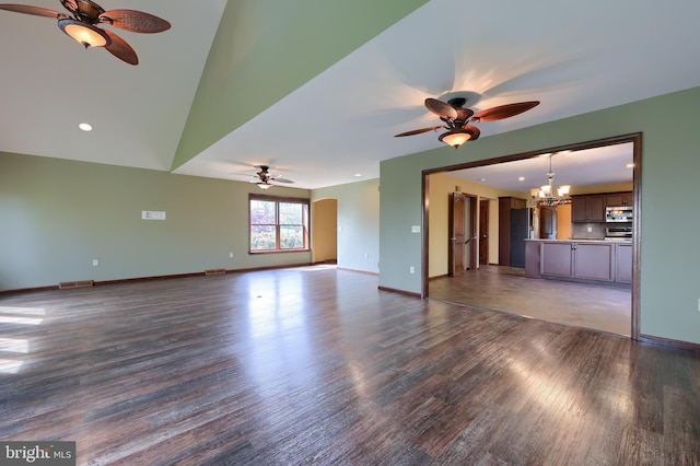 unfurnished living room featuring ceiling fan with notable chandelier, dark wood-style floors, visible vents, and recessed lighting
