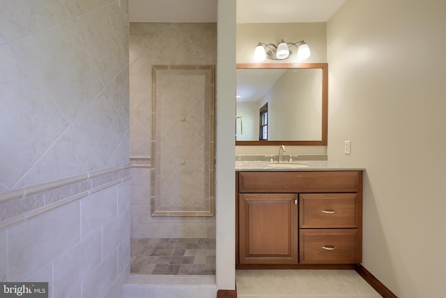 full bathroom featuring vanity and tiled shower