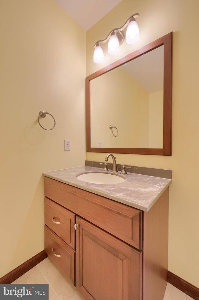 bathroom featuring baseboards, vanity, and tile patterned flooring