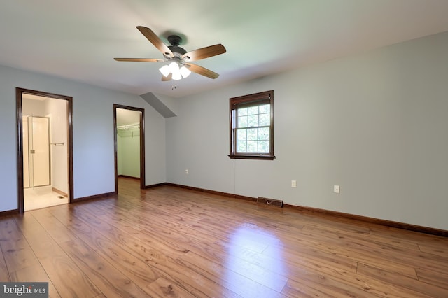 interior space with baseboards, ceiling fan, light wood finished floors, and visible vents