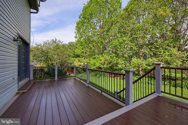wooden deck with a lawn