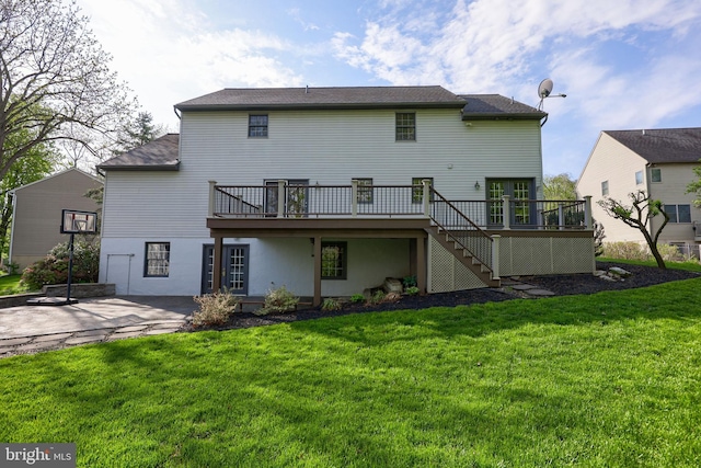 rear view of house featuring a yard, stairs, a patio, and a deck