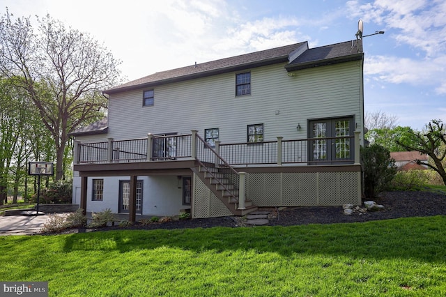 back of house featuring a yard, a deck, and stairway