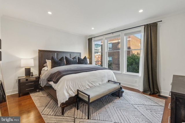 bedroom featuring ornamental molding and dark hardwood / wood-style floors