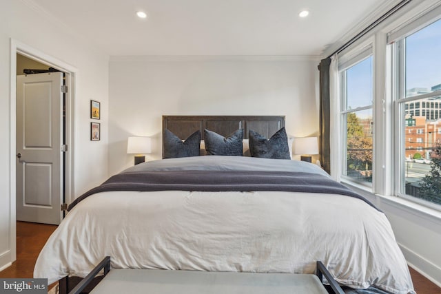 bedroom featuring crown molding and dark hardwood / wood-style floors