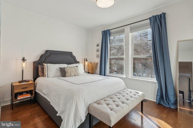 bedroom with dark wood-type flooring