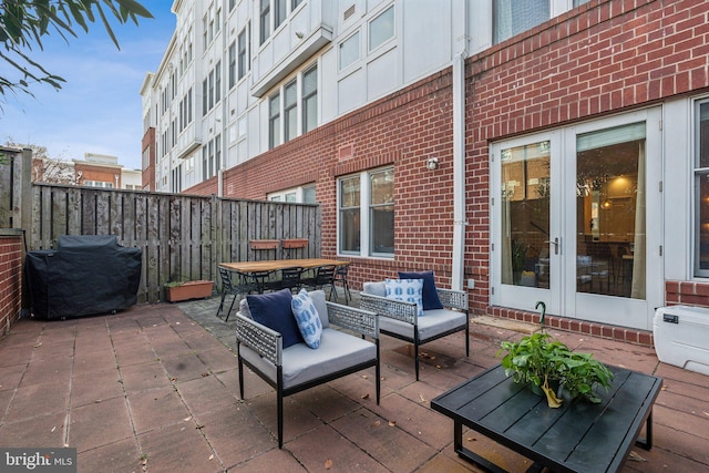 view of patio / terrace with an outdoor living space, french doors, and a grill