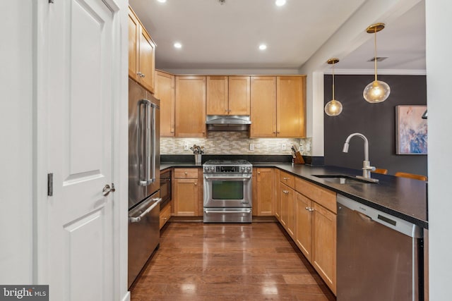 kitchen with sink, high quality appliances, tasteful backsplash, decorative light fixtures, and kitchen peninsula