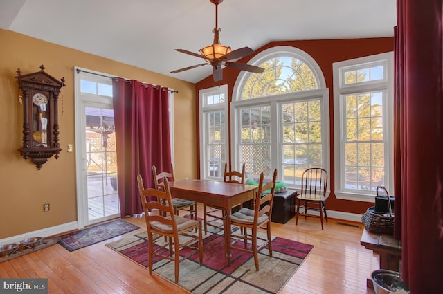 dining area featuring ceiling fan, lofted ceiling, and light wood-type flooring