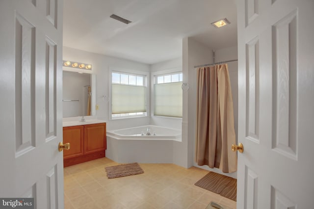 bathroom featuring vanity and shower with separate bathtub