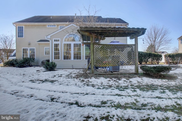 snow covered property featuring a pergola