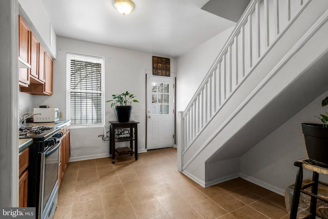 interior space featuring light tile patterned floors and stainless steel gas range