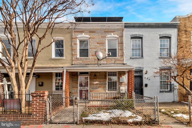 townhome / multi-family property with a porch