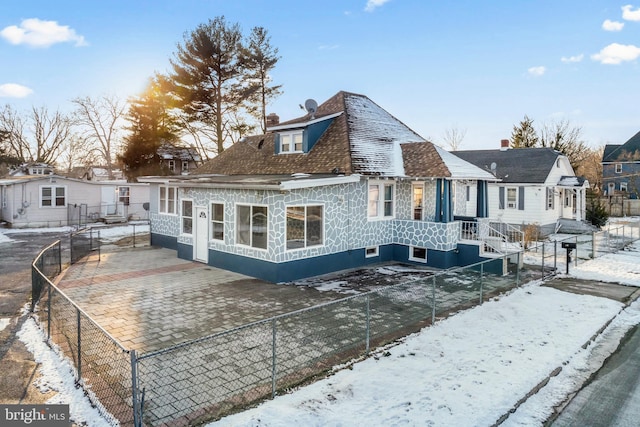 view of snow covered back of property