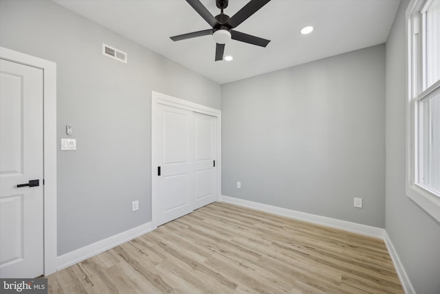 unfurnished bedroom featuring a closet, ceiling fan, and light hardwood / wood-style flooring