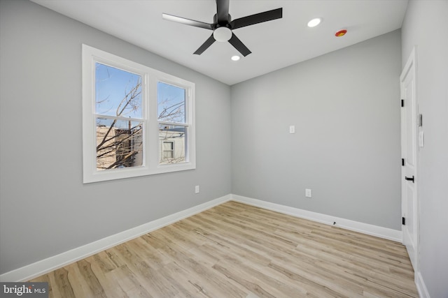 empty room with ceiling fan and light hardwood / wood-style flooring