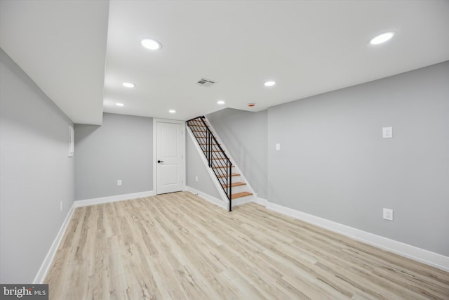 basement with light hardwood / wood-style floors