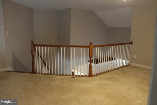 interior space featuring light carpet and lofted ceiling