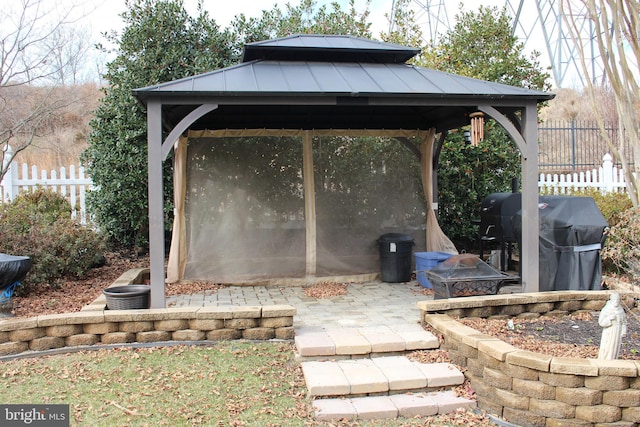 view of patio / terrace with a gazebo, a grill, and a fire pit