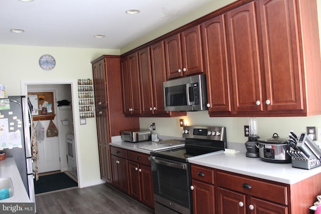 kitchen featuring dark wood-type flooring and appliances with stainless steel finishes