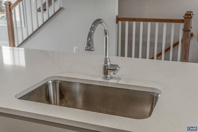 interior details featuring sink and light stone counters