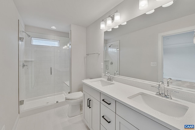 bathroom with tile patterned floors, vanity, toilet, and a shower with door