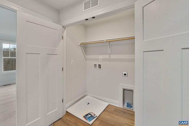 laundry area featuring electric dryer hookup, hookup for a washing machine, and hardwood / wood-style flooring