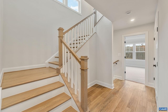 staircase with hardwood / wood-style floors