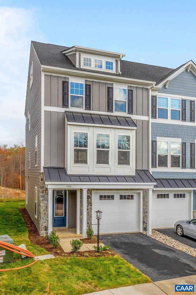 view of front of house with a garage and a front yard