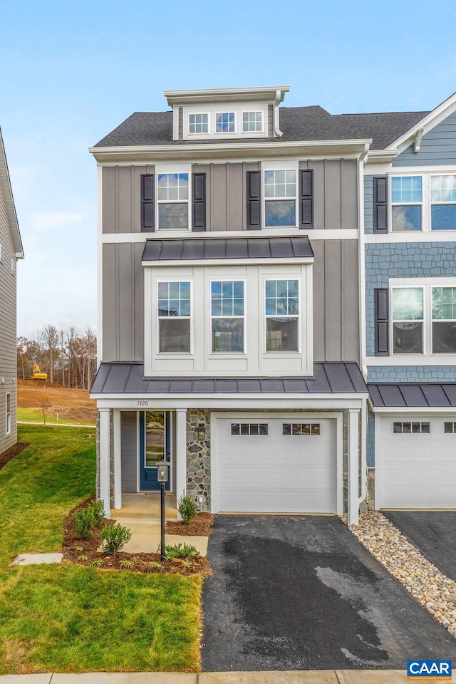 view of front of home with a garage and a front lawn