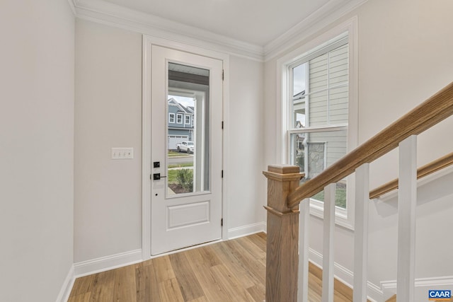 entrance foyer with crown molding and light hardwood / wood-style floors