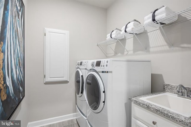 washroom featuring sink and washing machine and clothes dryer